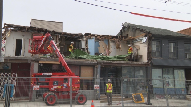 'Leaning' building deemed unsafe in unresolved 2014 inspection; Demolition crews were present at the 'leaning' building and adjoining units near Kensington Market on Saturday morning\. Crews began removing portions of the building Friday night\. 