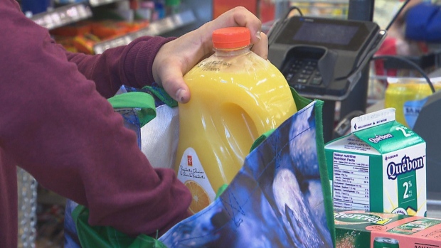 Like it or not — more of us are bagging our own groceries; a customer bagging groceries