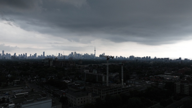 Parts of southern Ontario see more rain after record-setting downpours on Saturday; Aerial \(drone\) shots of large storm arriving in Toronto bringing torrential rain, thunder showers and wind\.