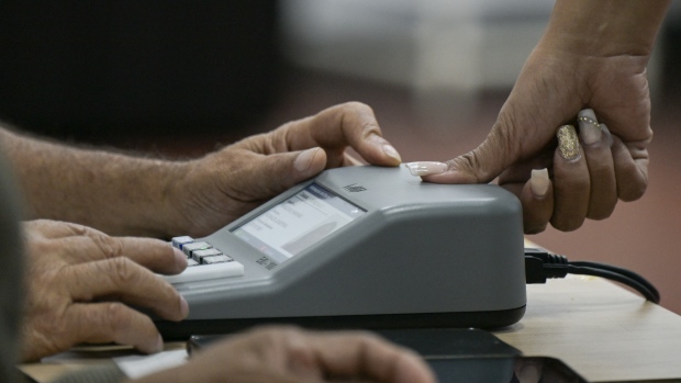 Biometrics in the workplace may be the way of the future. But at what cost?; A woman registers her fingerprint in a machine after voting during the Venezuelan presidential election, in Caracas on July 28, 2024\. Venezuelans vote Sunday between continuity in President Nicolas Maduro or change in rival Edmundo Gonzalez Urrutia amid high tension following the incumbent's threat of a "bloodbath" if he loses, which polls suggest is likely\. \(Photo by Yuri CORTEZ / AFP\) \(Photo by YURI CORTEZ/AFP via Getty Images\)