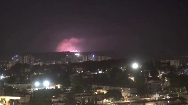 Israel carries out airstrikes on Lebanon as Hezbollah fires hundreds of rockets at Israel; In this screenshot from video footage provided by Reuters, explosions and projectiles were seen flying over Israel's northern border with Lebanon Sunday morning, as the Israeli military said it was carrying out preemptive airstrikes against the militant group Hezbollah\. 