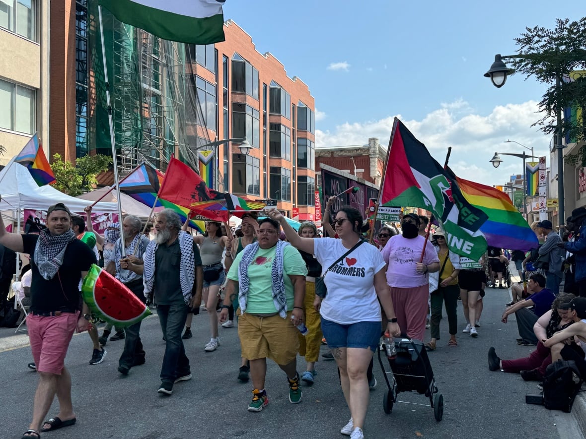 A group of people marching in the Capital Pride Parade in downtown Ottawa Aug. 25, 2024.