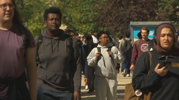 New limits on international students are causing turmoil among colleges, universities; Students walk down an alley at the University of Manitoba during the first week of Fall semester classes\.
