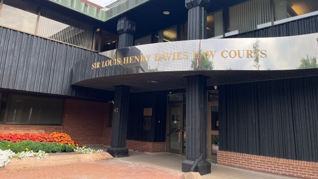 The sentencing took place Friday at the P.E.I. Supreme Court in Charlottetown. Two-storey building with sign saying "Sir Louis Henry Davies Law Courts."