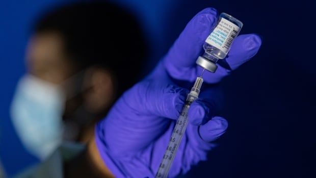 A family nurse practitioner prepares a syringe with the Mpox vaccine for inoculating a patient at a vaccination site in the Brooklyn borough of New York in 2022. 