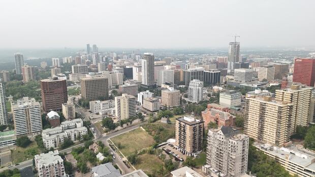 Applications for multi-unit residential projects in Edmonton have increased by nearly 200 per cent since last year. Towers are seen on a smoky day.