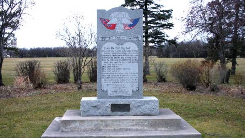 A stone monument stands in a park