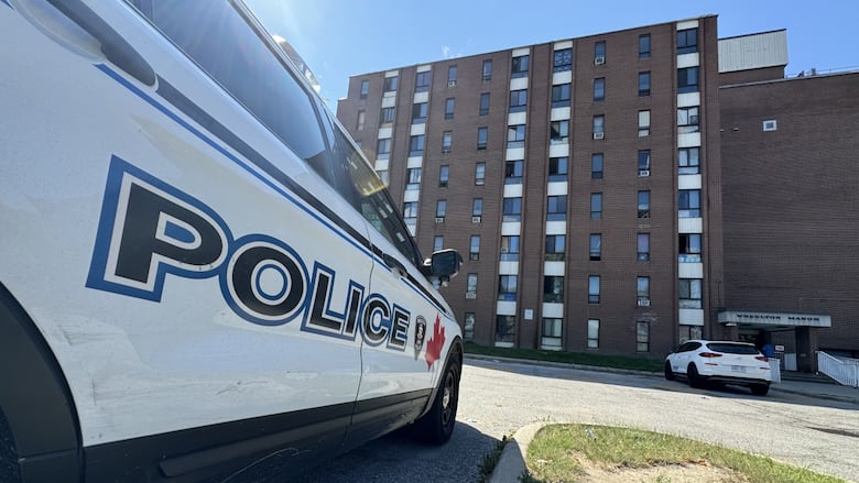 windsor police cruiser parked with the Glengarry apartment building in the background