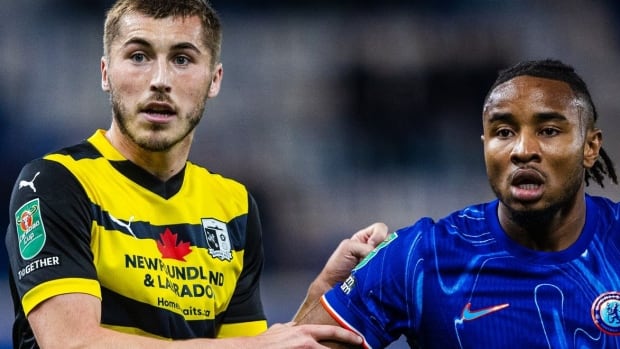 Two soccer players battle for place on the field.