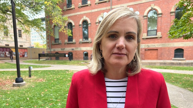 Contract for new Health P.E.I. CEO includes non-disparagement clause; Woman with red blazer over striped shirt\.