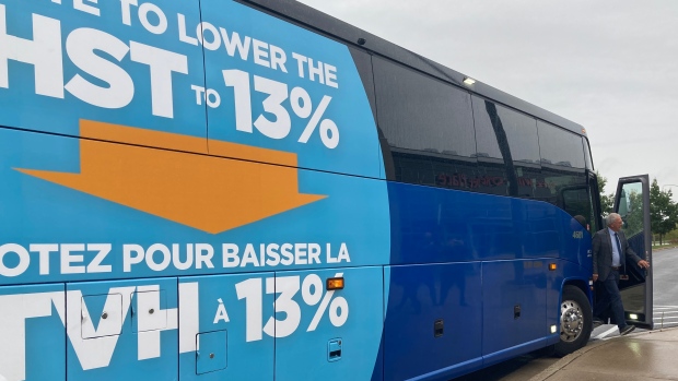 Billion-dollar election platforms pose threat to 8-year streak of N.B. budget surpluses; Progressive Conservative leader Blaine Higgs exiting his campaign bus, witch is emblazoned with the party's promise to cut the HST by two per cent\.