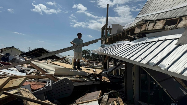 At least 44 dead across 5 states, as Hurricane Helene rips through southeastern U.S.; Hud Lilliott surveys what's left of his home after Hurricane Helene passed the area at Dekle Beach, Fla\., in rural Taylor County on Friday\. \(AP Photo/Kate Payne\)