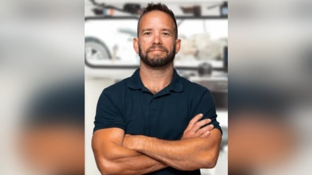 Fredericton police have charged a 17-year-old boy with manslaughter in the death of André Bourgeois, 41. A smiling dark-haired man with a goatee in a short-sleeved black shirt with his arms folded in front of him.