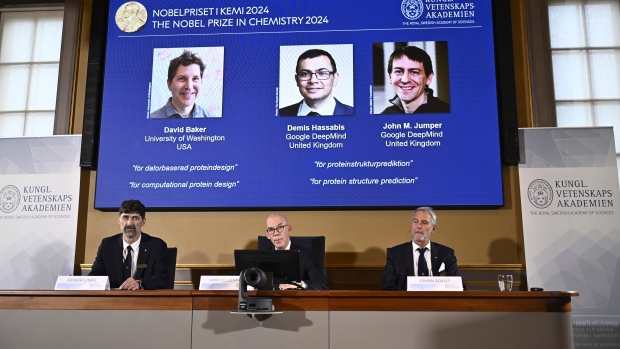 Nobel chemistry award goes to trio of scientists researching protein structure; The prize winners are projected on a screen in Stockholm on Wednesday above, from left to right, Johan Aqvist, member of the Nobel Committee for Chemistry, Hans Ellegren, Permanent Secretary of the Royal Swedish Academy of Sciences, and Heiner Linke, Chairman of the Nobel Committee for Chemistry\.