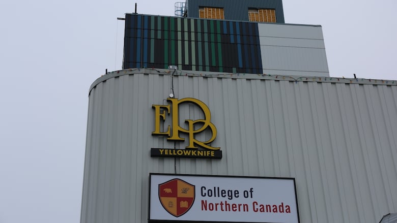 A sign on a building on a cloudy day.