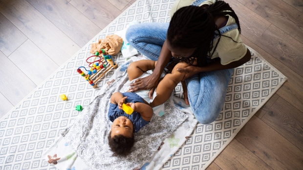 Parenting is hard. The '17 diapers' trend gets honest without shame; Mom changes her baby's diaper\.