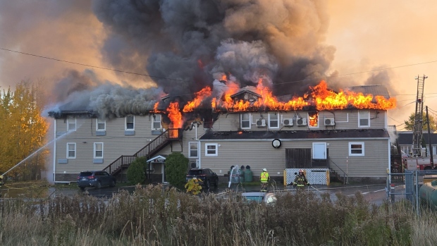 Volleyball moms serve up plea for action after tragic Driftwood Inn fire; This photo, taken around 8 a\.m\. on Saturday, Oct\. 19, shows the fire had spread to the second floor at that point\.