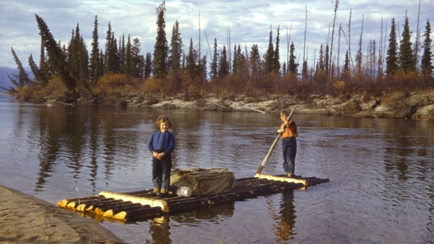 Historical film about family's backcountry trek through the Yukon rescued from obscurity; Jo-evelyn Albee, 5, and Billy Albee, 8, in the fall of 1940\. The raft the children are standing on was built by their father, Bill\. 