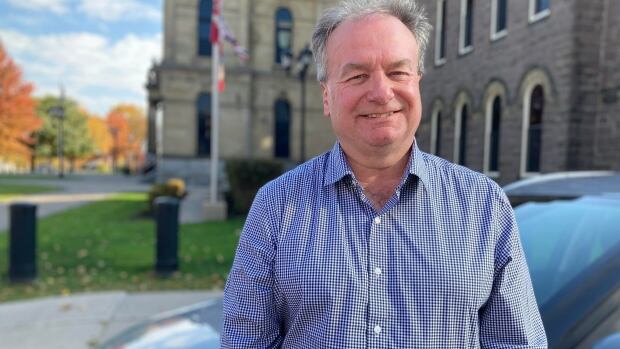 Aaron Kennedy, Quispamsis MLA and recently sworn in Minister of Local Government and Minister Responsible for Service New Brunswick, says early steps towards fiscal reform would start in 2025. Man smiling at camera.