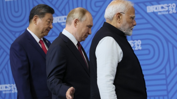 India makes it clear it's not interested in a Western alliance; From left: Chinese President Xi Jinping, Russian President Vladimir Putin and Indian Prime Minister Narendra Modi attend a family photo ceremony prior to the BRICS Summit plenary session in Kazan, Russia, Wednesday, Oct\. 23, 2024\.