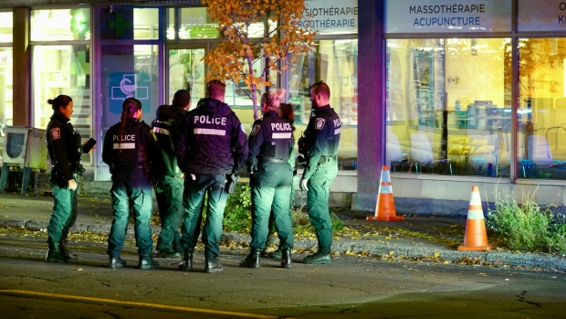 7 people injured after being struck by car in Montreal; Police officers gathered on a street\. 