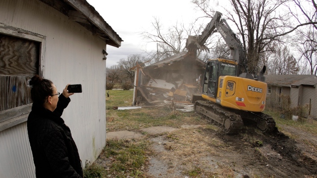 Rebuild or retreat? Repeat flooding forces tough decisions on homeowners, governments; Tammy Kilgore watches while her former home is demolished as part of a voluntary buyout in flood-prone Mosby, Mo\., in 2019\. Kilgore accepted a \$45,000 US payment to leave her home of 38 years and has moved to a nearby community\.