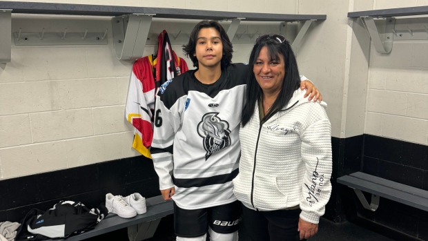 Cost, distance keeping Gino Odjick's nephew from playing high-level hockey, family says; Marcus Odjick and Dina Odjick pose for a photo in the locker room\.