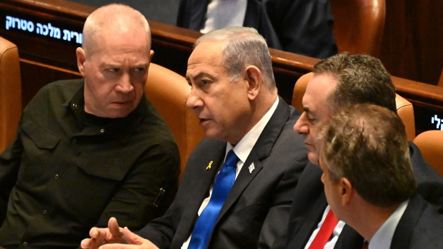 Israeli PM dismisses defence minister, sparking protests across country; Israeli Prime Minister Benjamin Netanyahu, center, speaks to Defense Minister Yoav Gallant, left, at the opening of the 25th Knesset session marking the anniversary of the 'Iron Swords' war, in Jerusalem, Monday, Oct\. 28, 2024\.