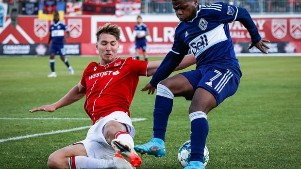 Vancouver Whitecaps forward Deiber Caicedo and Calgary Cavalry defender Daan Klomp battles for the ball during second-half soccer action in the Canadian Championship quarterfinal in Alberta on May 25, 2022.