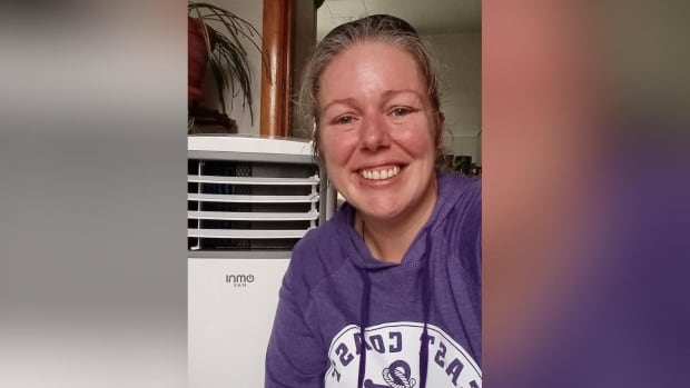 Woman smiles in a selfie. 