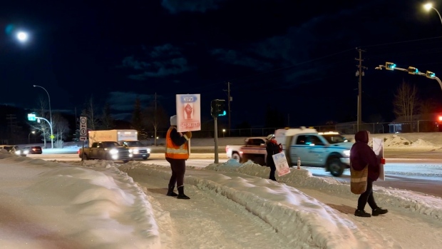 Workers' safety key concern for northern Canada Post workers who spend hours walking in cold; Whitehorse Canadian Union of Postal Workers \(CUPW\) members walking the picket line Friday morning at the top of Two Mile Hill\.