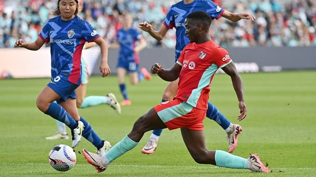 Kansas City Current forward Temwa Chawinga stretches her left leg to kick the ball in a Nov. 9, 2024 National Women’s Soccer League playoff match against Narumi Miura and the North Carolina Courage at CPKC Stadium in Kansas City, Missouri. 