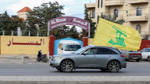 After a costly war with Israel, Hezbollah now must tackle complex challenges of rebuilding; A vehicle decorated with the flag of the Lebanese movement Hezbollah, drives on a road as residents return to the city of Baalbek on November 27, 2024, after a ceasefire between Hezbollah and Israel took effect\. A ceasefire between Israel and Hezbollah in Lebanon took hold on November 27 after more than a year of fighting that has killed thousands\. 