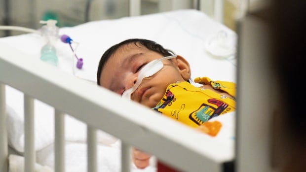 A kid  suffering from an RSV astatine  a pediatric intensive attraction   portion   successful  Germany.