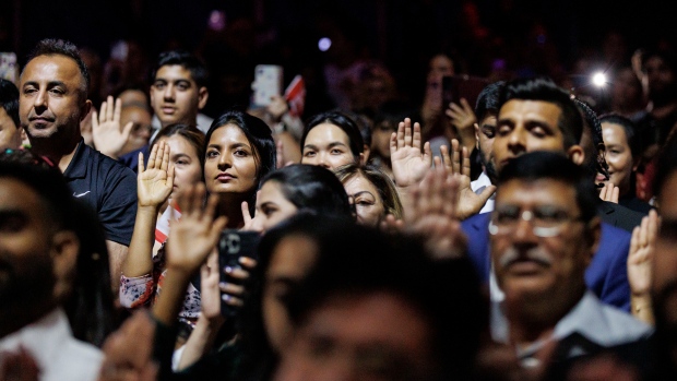 Newcomers feel Canada accepts 'too many immigrants' without proper planning, CBC survey finds; Some 400 new Canadians take part in a citizenship ceremony, presided over by immigration minister Marc Miller and held under the Cirque du Soleil big top, in Toronto, on July 19, 2024\.