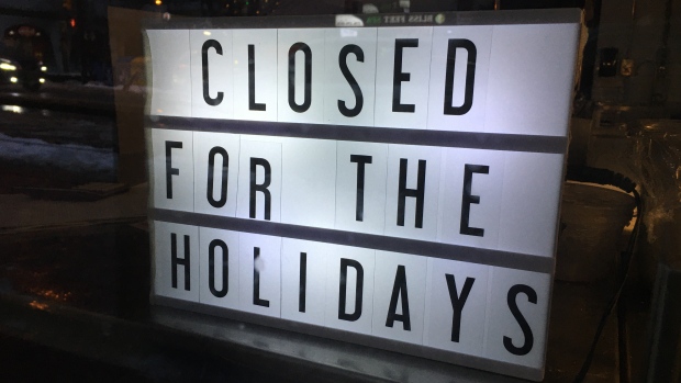 Many P.E.I. businesses and services will be closed on New Year's Day; An illumniated sign that reads 'CLOSED FOR THE HOLIDAYS' is displayed in the window of a downtown restaurant that has gone dark for the holiday season during a time of staffing shortages and increased covid measures\. Taken at night on 2-Jan, 2021
