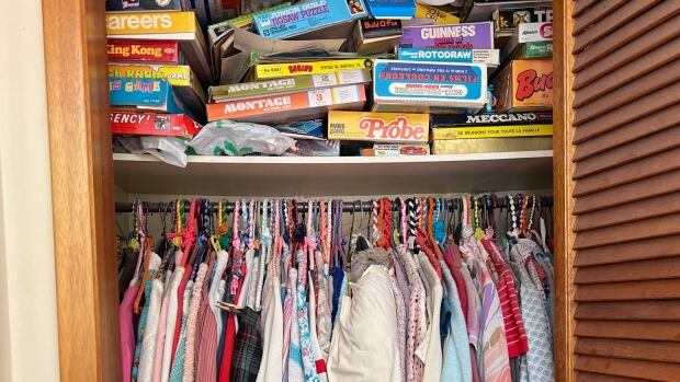 When it comes to sorting inherited clutter, Kim Eagles said children should focus on keeping what they have a personal connection to instead of what their parents did. A closet full of clothes and board games.