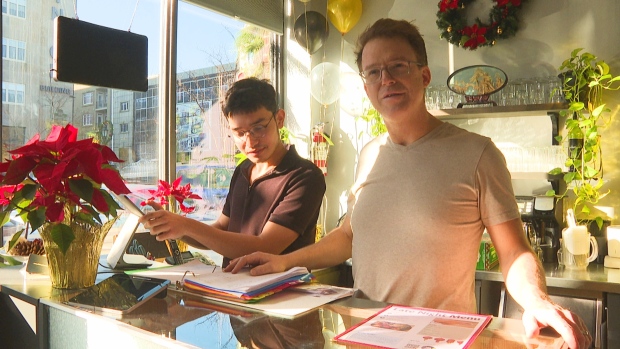 Chinese restaurant in Charlottetown taking a New Year's tradition to a new level; Two men behind a counter at Chinese restaurant\.