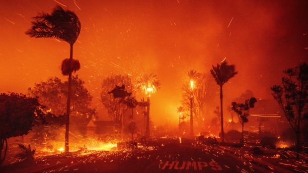 Wildfires rage through L.A., forcing thousands to flee as homes, businesses burn; The Palisades Fire ravages a neighborhood amid high winds in the Pacific Palisades neighborhood of Los Angeles, Tuesday, Jan\. 7, 2025\. \(AP Photo/Ethan Swope\)