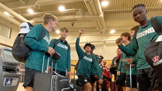 In 2029, New Brunswick athletes won't need to travel far for the Canada Games as the event will be held in their home province. Moncton and Saint John are submitting a joint bid to act as the host city. A group of young boys at an airport wearing green "Team NB" shirts.
