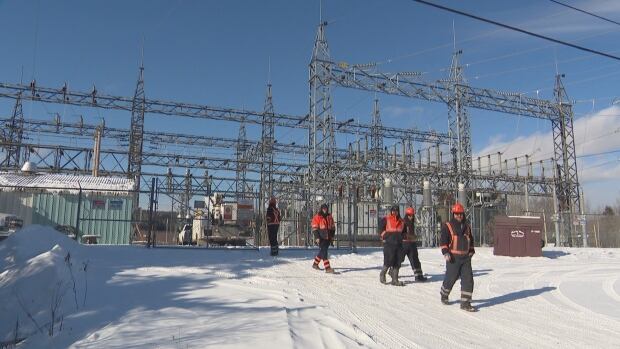 A second power outage hit Edmundston Wednesday. Line workers near sub station in snow.