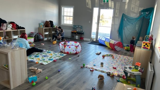 A room at a daycare centre is filled with toys.