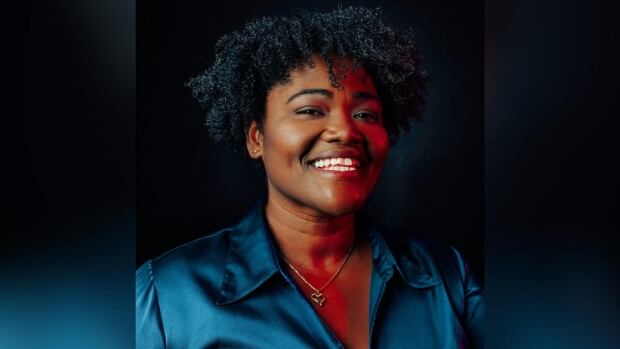 A woman smiles.