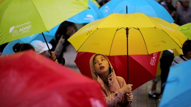 New study suggesting people with ADHD have shorter lifespans should be 'call to arms,' lead author says; Young children dance with their umbrellas at the launch of an art installation called the Umbrella Project, featuring 200 brightly coloured umbrellas suspended over Church Alley on June 22, 2017 in Liverpool, England\. The project is to raise awareness of ADHD and autism in children\. Local school children also performed a dance at the launch despite the rain\. The ADHD Foundation wants the project to inform the public "that young people with ADHD and other conditions possess many gifts and can succeed in their community despite their condition"\.  