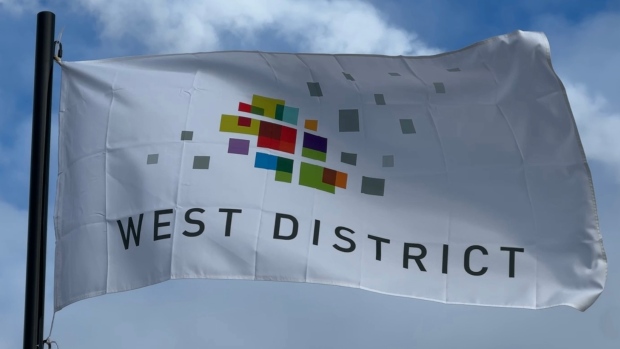 Application to triple height of condo towers sparks concern over density; A marketing flag flies alongside the site where new condos are panned in West District\.