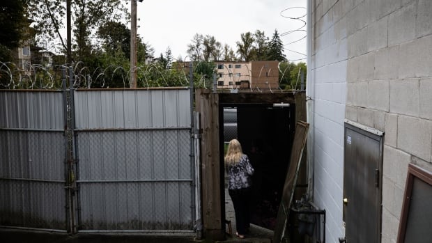 Apartment entrance is fortified with barbed wire, metal gates, and a metal door with a deadbolt in Maple Ridge on Monday, September 23, 2019. (Maggie MacPherson/CBC) An apartment entrance is fortified with barbed wire, metal gates, and a metal door with a deadbolt.
