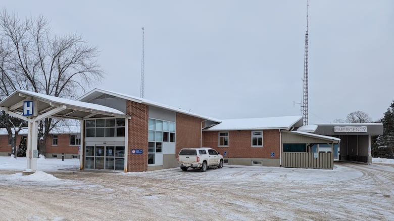 A single storey building with a two story entrance with a big H in white on a blue background and am emergency entrance to the right.