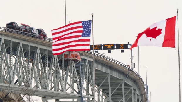 The trade war is off — but for how long?; The US and Canadian flags fly on the US side of the St\. Clair River near the Bluewater Bridge border crossing between Sarnia, Ontario and Port Huron, Michigan on January 29, 2025\. The Bank of Canada on January 29 cut its key lending rate 25 basis points to 3\.0 percent, noting that US tariff threats are creating uncertainty for the economy\.""The economy is expected to strengthen gradually and inflation to stay close to target \(of two percent\)," the central bank said\. "However, if broad-based and significant tariffs were imposed, the resilience of Canada's economy would be tested\." \(Photo by Geoff Robins / AFP\) \(Photo by GEOFF ROBINS/AFP via Getty Images\)