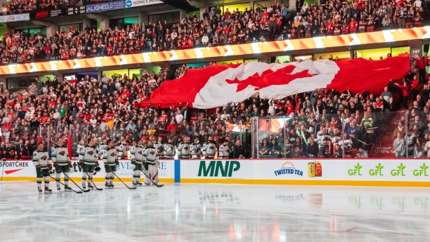 WATCH | Canadian hockey fans boo U.S. anthem during Ottawa Senators, Minnesota Wild game; The Canadian flag is passed along during the National Anthem prior to start of game between the Minnesota Wild and the Ottawa Senators at the Canadian Tire Centre\. 
