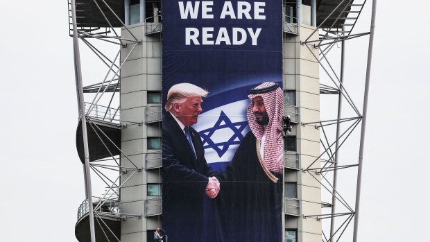 As Netanyahu and Trump meet in Washington, doubts remain about how much Israel's leader wants to end the war; A billboard by the Coalition for Regional Security, that promotes a regional peace deal, is hung during a Washington trip by Israeli Prime Minister Benjamin Netanyahu to strengthen ties with U\.S\. President Donald Trump, in Ramat Gan, Israel February 3, 2025\. 